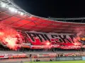 Tłum kibiców, ultrasi, tworzy morze czerwonego dymu i ognia, rozwijając ogromny transparent "POLSKA".