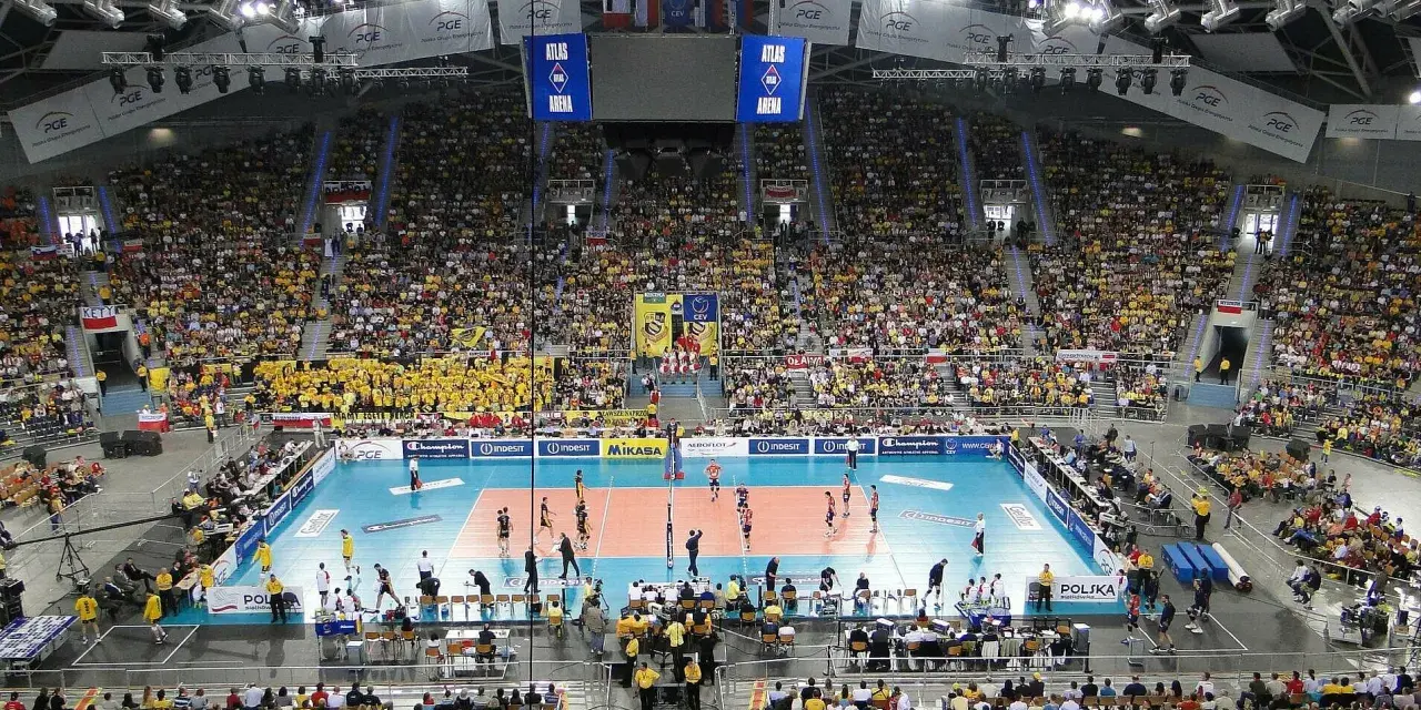 Widok na pełną trybunę Atlas Arena podczas meczu siatkówki. Tysiące kibiców w żółtych barwach tworzy gorącą atmosferę.