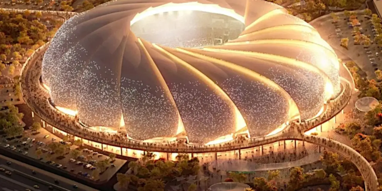 Futurystyczny stadion, który może być najładniejszy na świecie, z falującym dachem i oświetlonymi detalami, otoczony zielenią i tłumem ludzi.