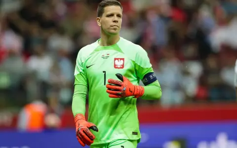 Wojciech Szczęsny, bramkarz reprezentacji Polski, w zielonej koszulce i pomarańczowych rękawicach. Jego imponujący wzrost pozwala mu skutecznie bronić.