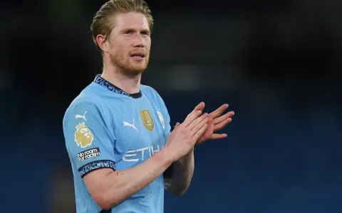 Kevin De Bruyne w błękitnej koszulce Manchesteru City klaszcze, wyrażając uznanie dla kibiców.