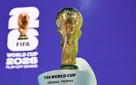 Złote trofeum FIFA World Cup na tle logo turnieju 2026. Już niedługo dowiemy się, kiedy otwarcie mistrzostw świata w piłce nożnej!
