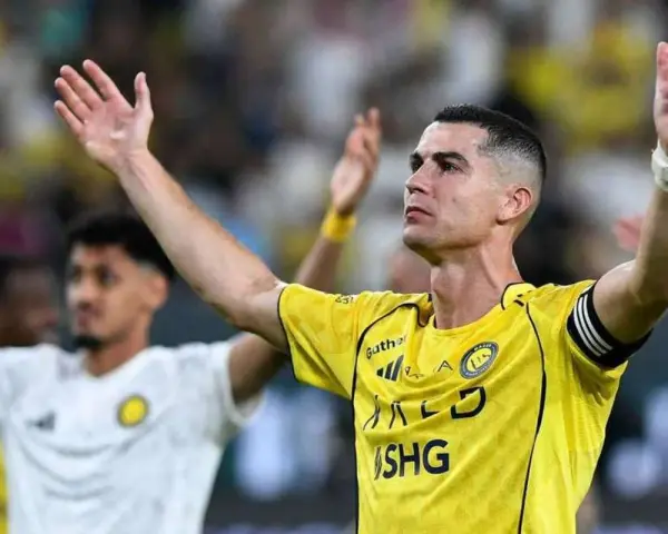 Cristiano Ronaldo w żółtej koszulce z podniesionymi rękami. Ile goli strzelił Ronaldo?